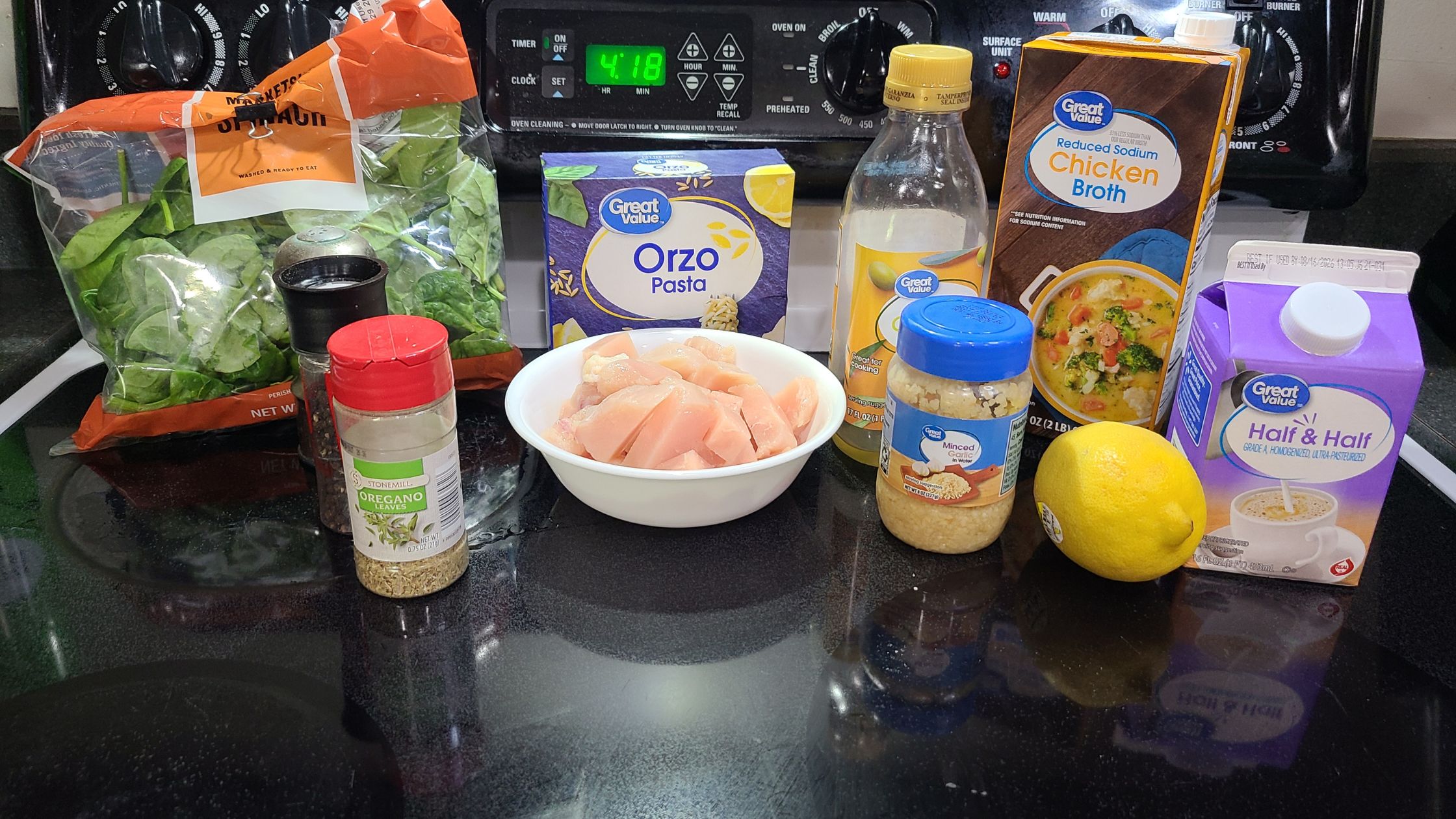 Ingredients for lemon chicken orzo, on a stovetop