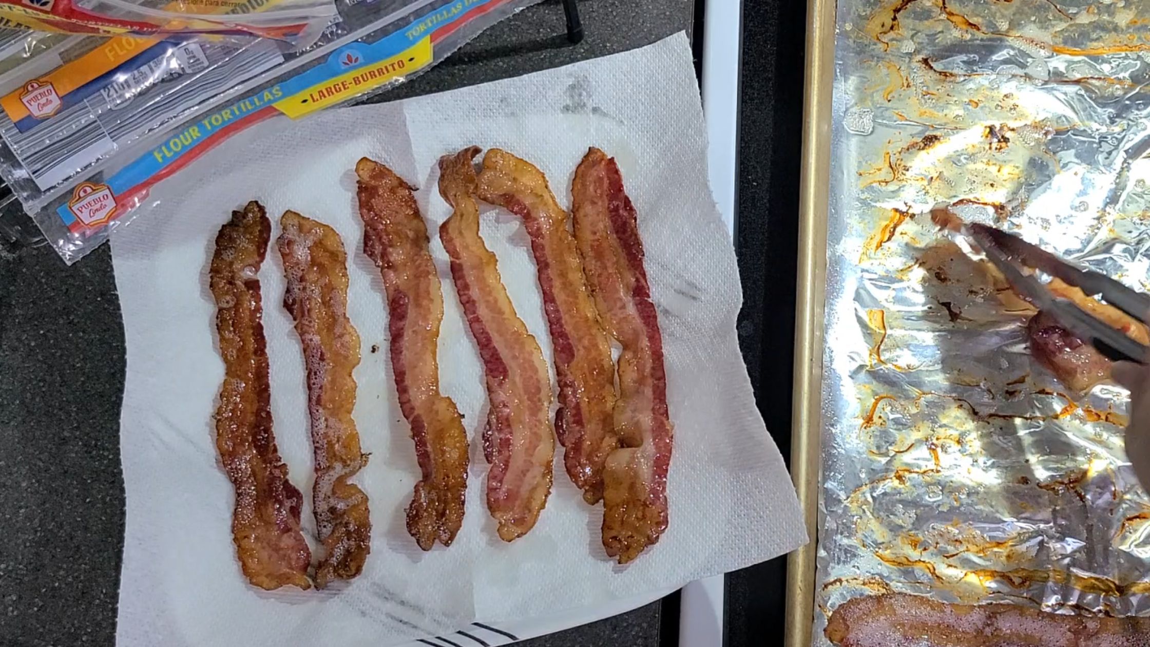 Cooked bacon laying on a paper towel